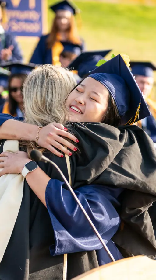 Graduate embracing someone