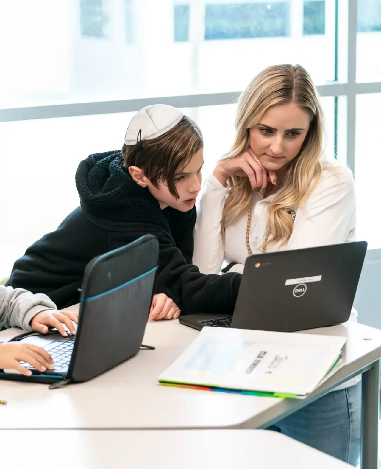 Lower school student with teacher with laptop
