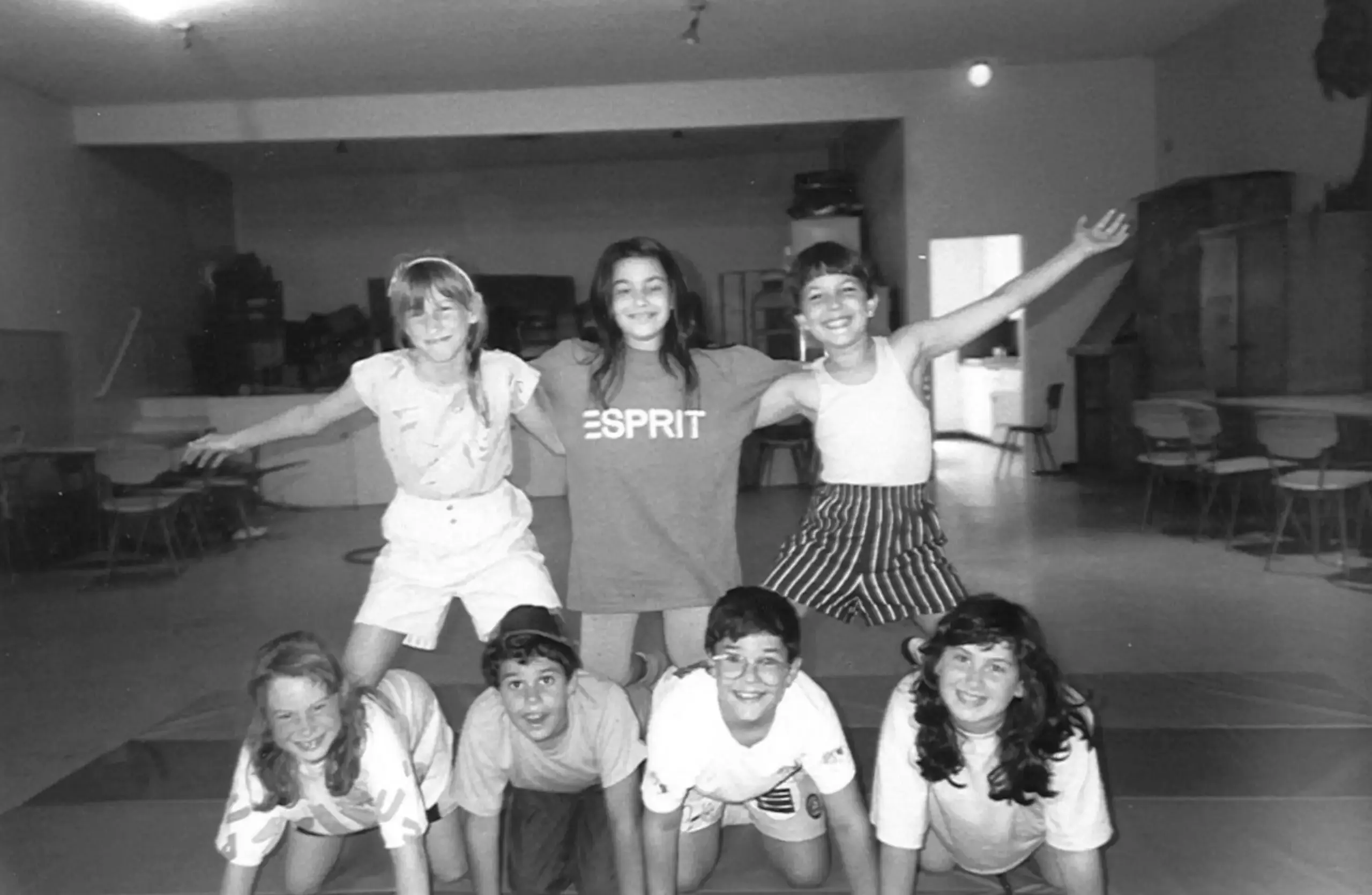 Black and white photo of students making human pyramid