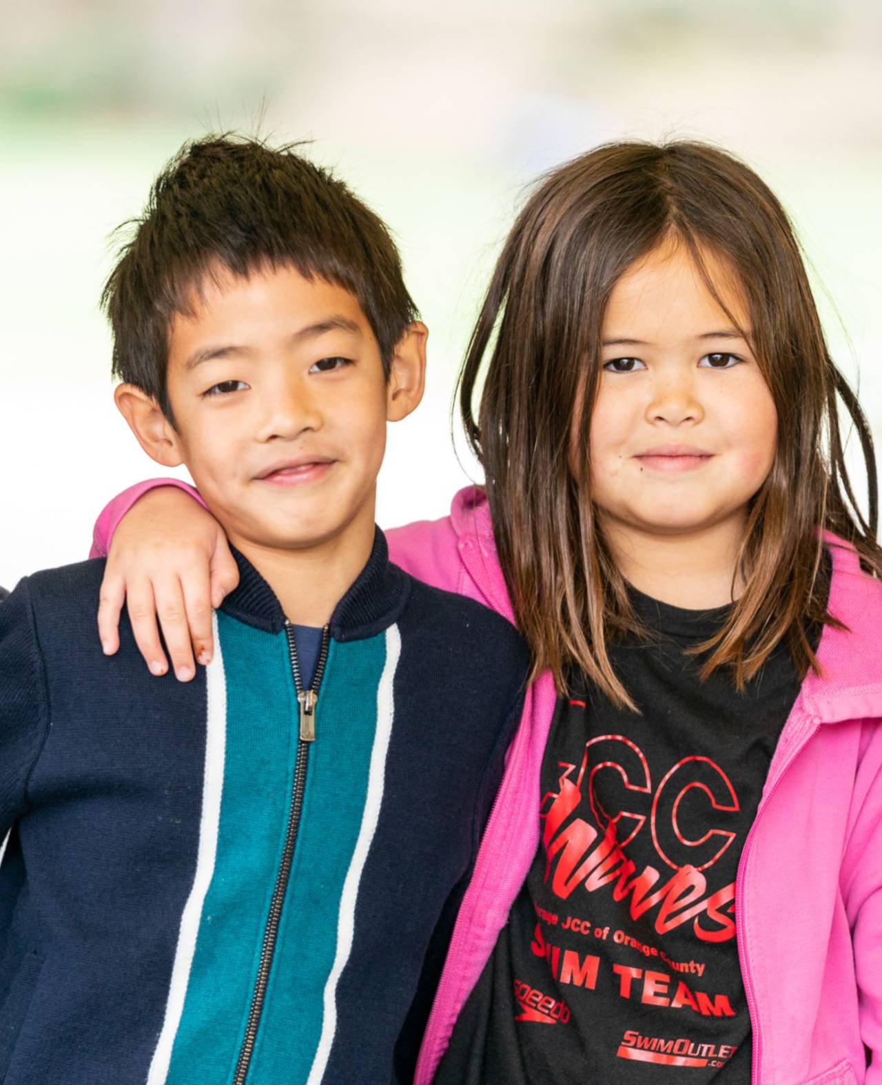 Two students, one with their arm wrapped around the other's shoulder