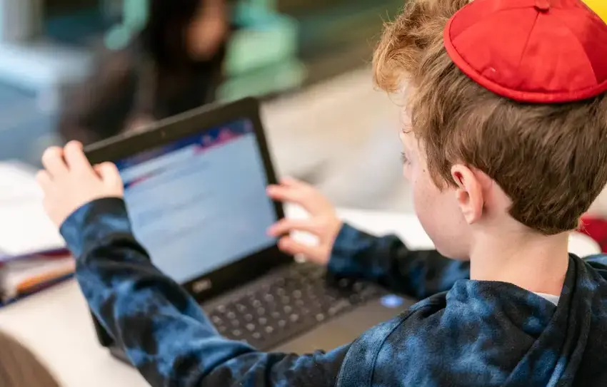  photography of Lower School students engaging in robotics