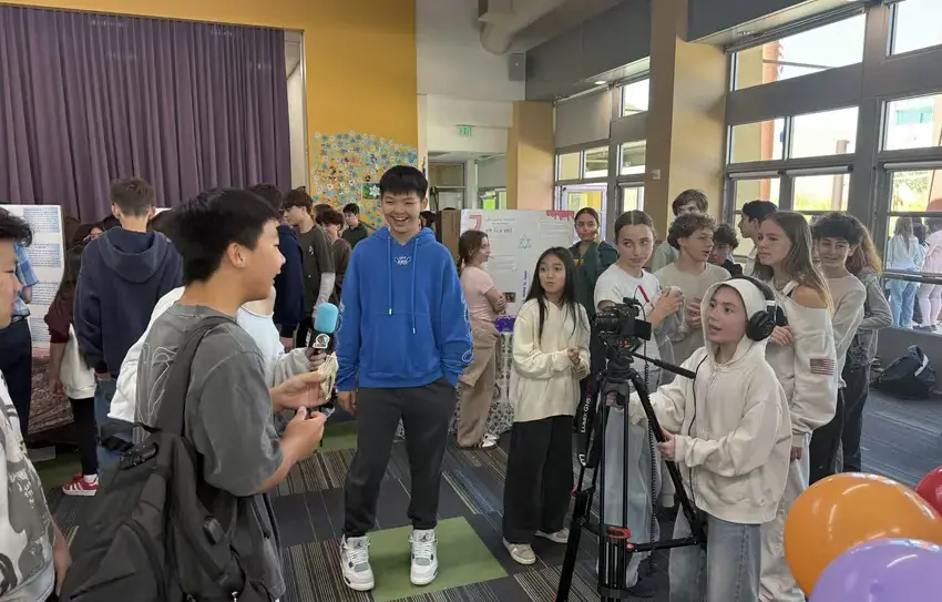  photography of Upper School students broadcasting a school news show