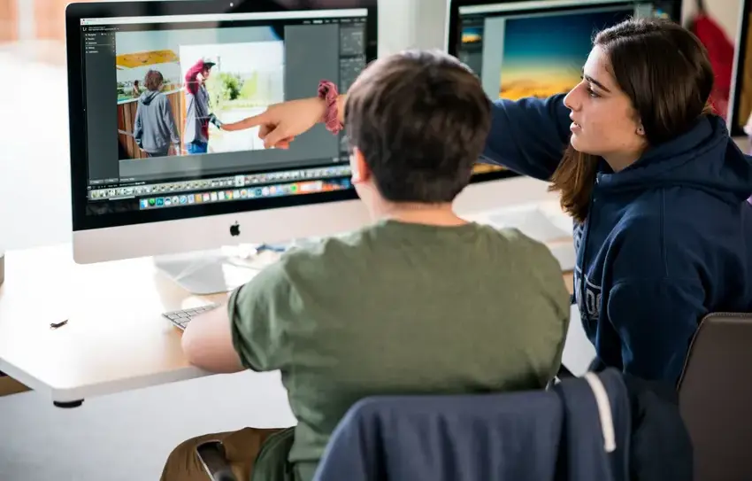 photography of filmmaking Middle School student working with camera/editing