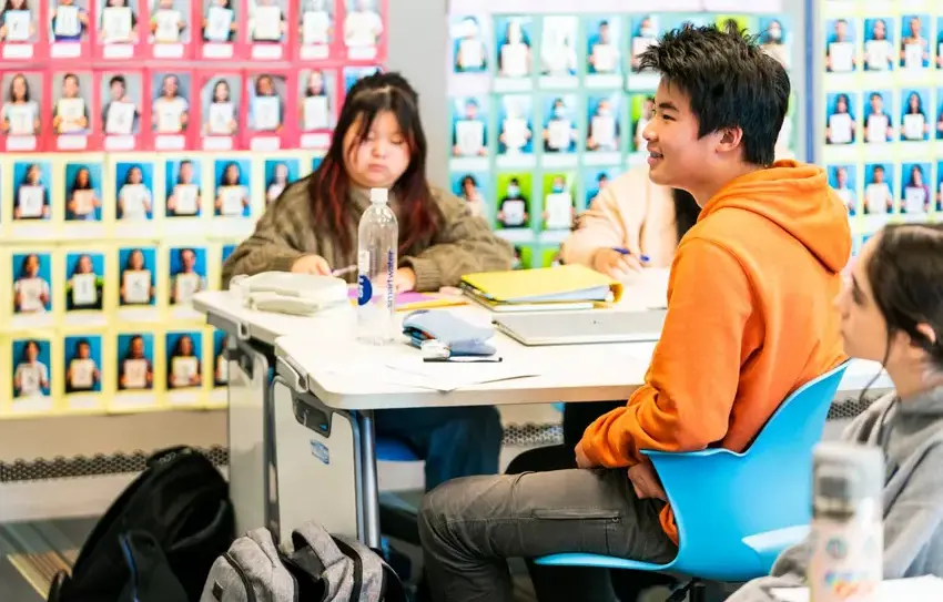 photography of middle school Math Team gathered around a desk together