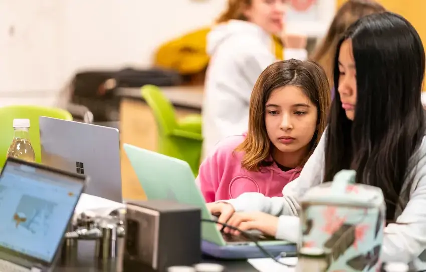 photography of Middle School students working together on a project