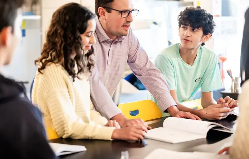 photography of Upper School students working at white board together