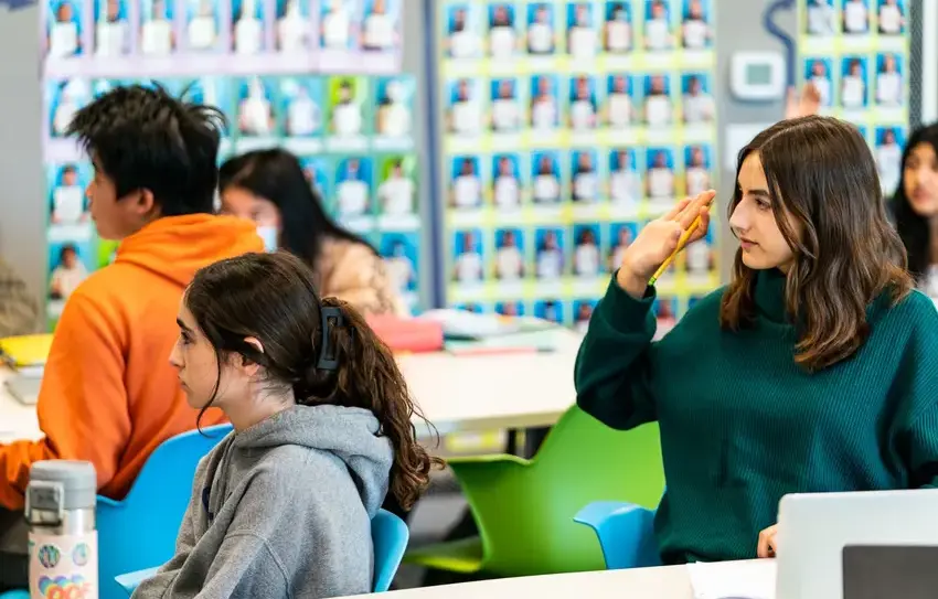 photography of Upper School students working together on an equation at a Fab Lab whiteboard