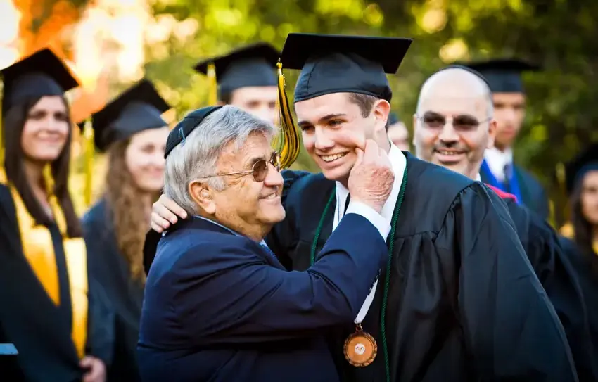 Irving Papa Gelman with student at graduation