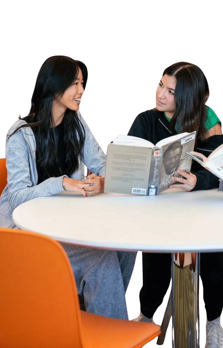 Upper school students around a table